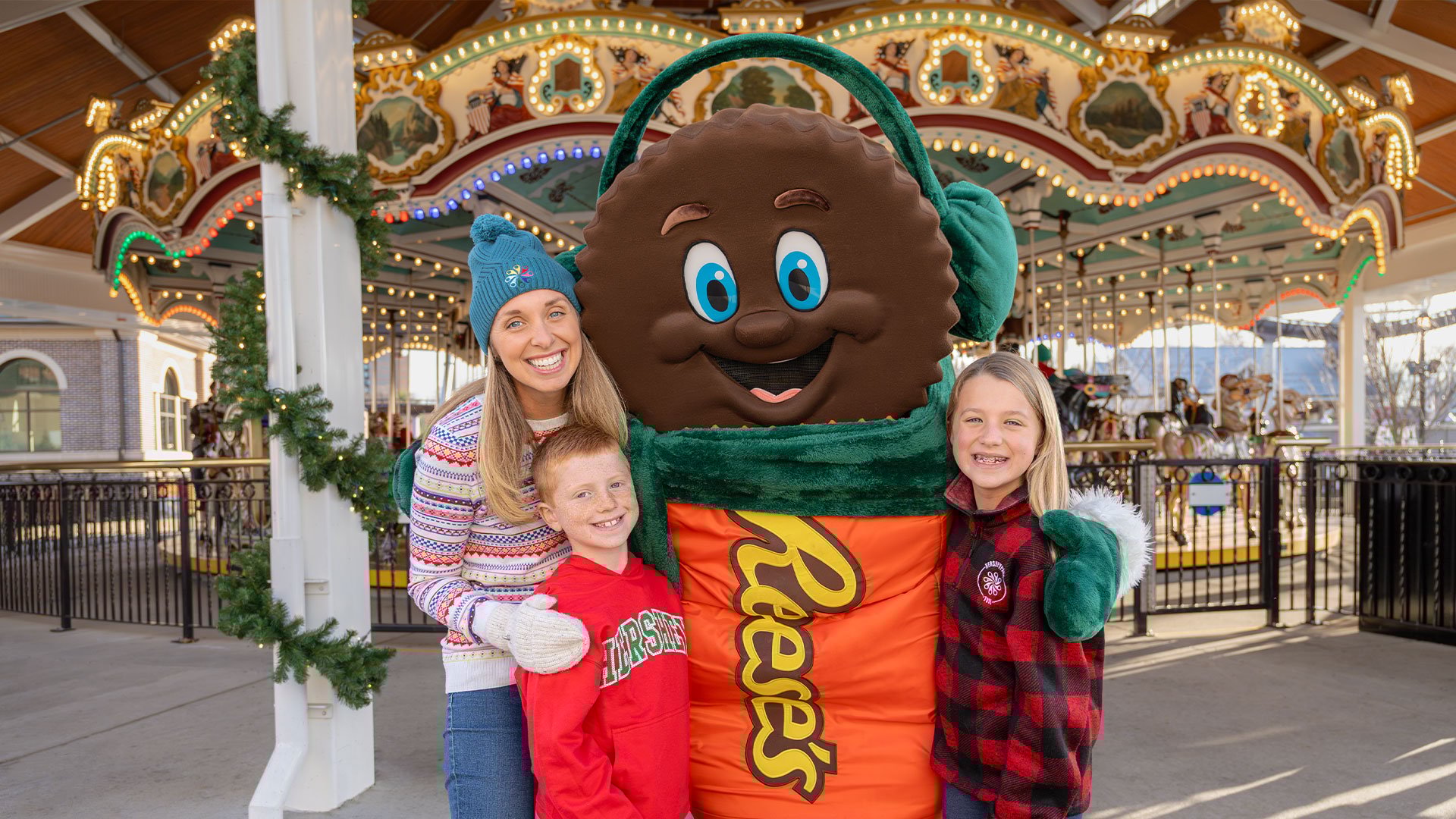 family-smiling-with-reeses-character-dressed-for-holidays-hersheypark.jpg