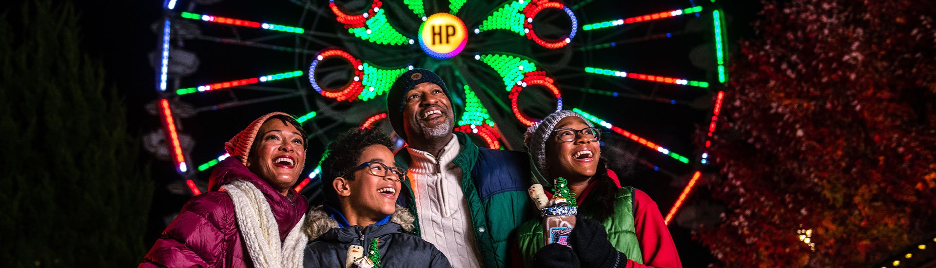 smiling-family-in-front-of-hersheypark-ferris-wheel-during-holiday-season.jpg