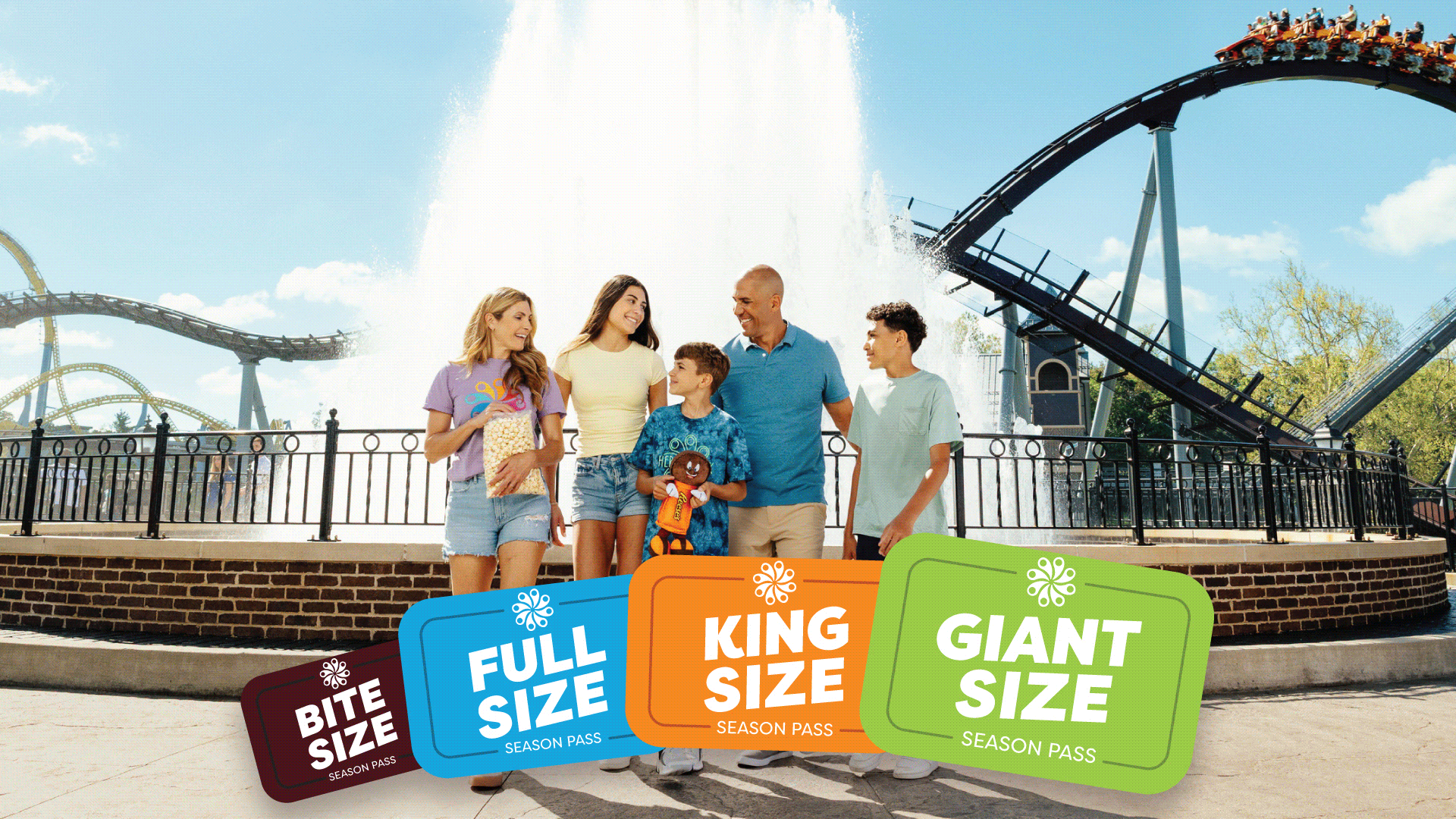 family-in-front-of-kissing-fountain-kids-at-boardwalk-dark-nights-hersheypark-season-passes.gif