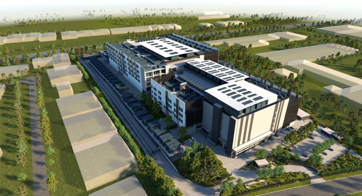 Vue aérienne d'un complexe industriel moderne avec panneaux solaires, entouré de verdure et de parkings.