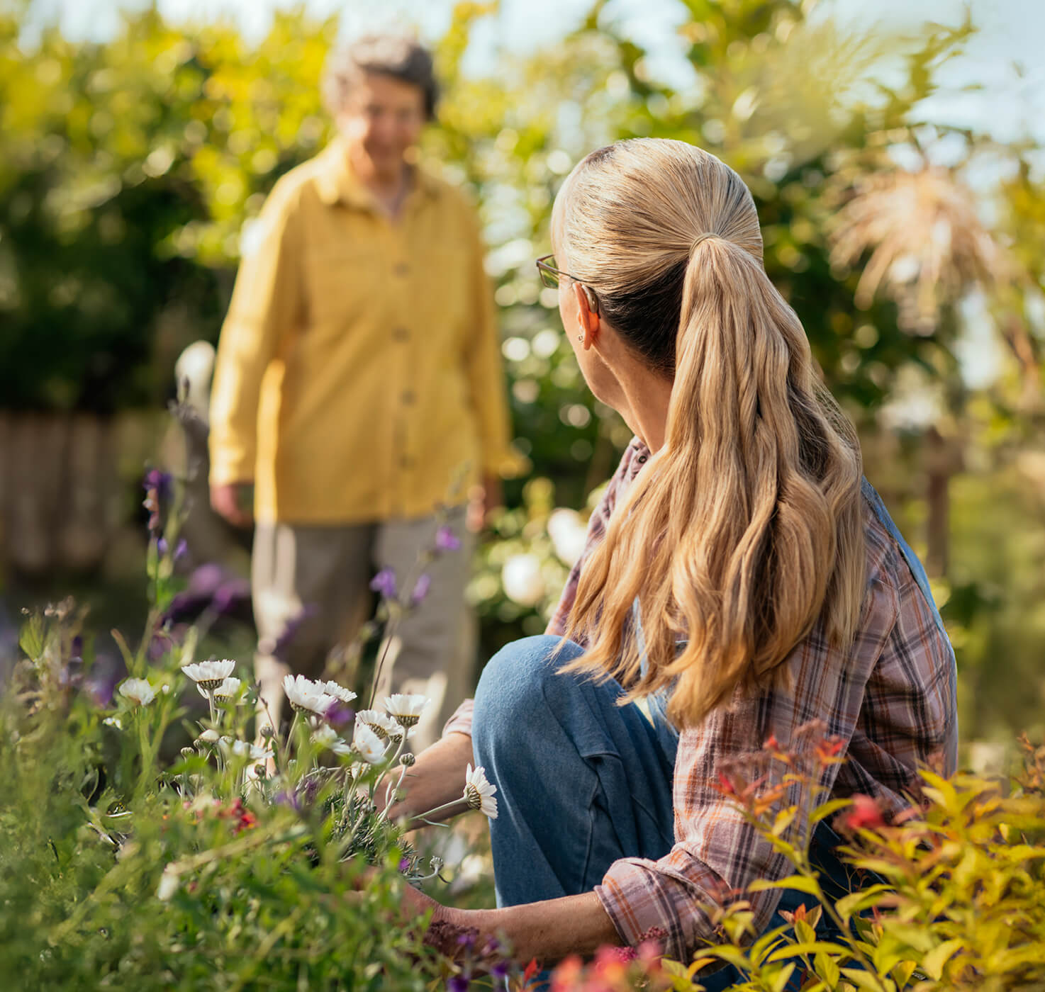 man approaching woman in a garden