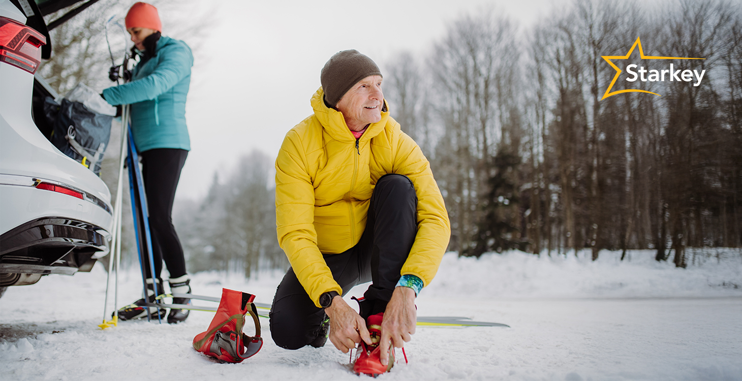 Image of senior man outdoors tying his cross-country ski boots