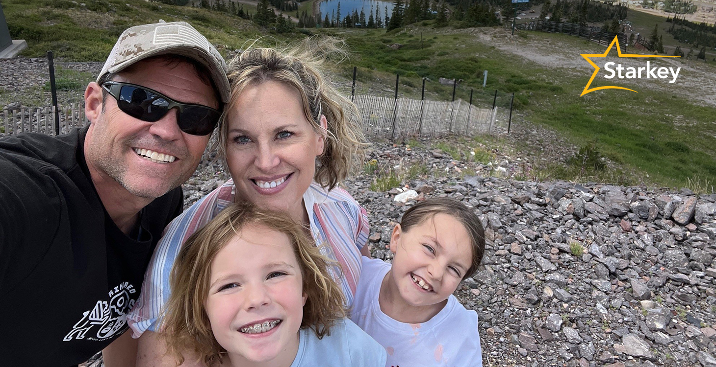 Image of Justin Osmond and wife and daughters taking a selfie on the top of a hill