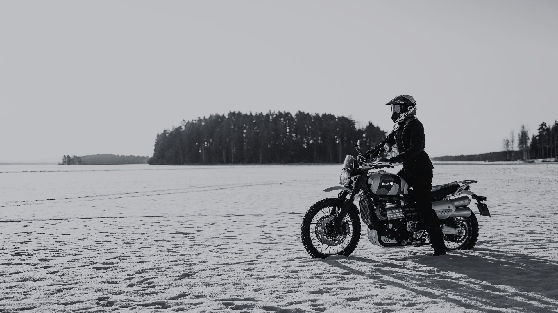 Image of a woman on a triumph motorbike in snow