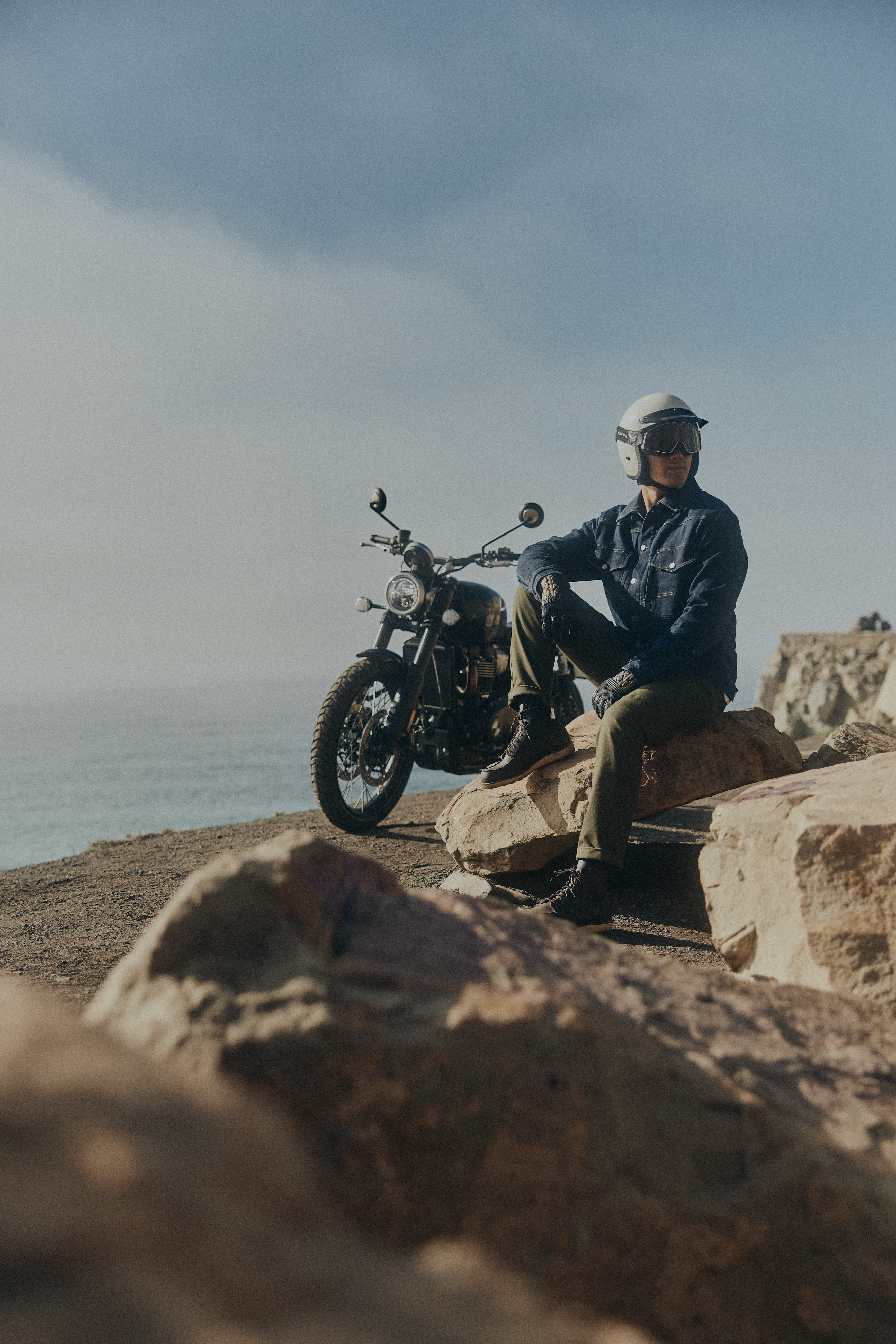 Man sat on a rock wearing Triumph Jax Modern Classics Jacket