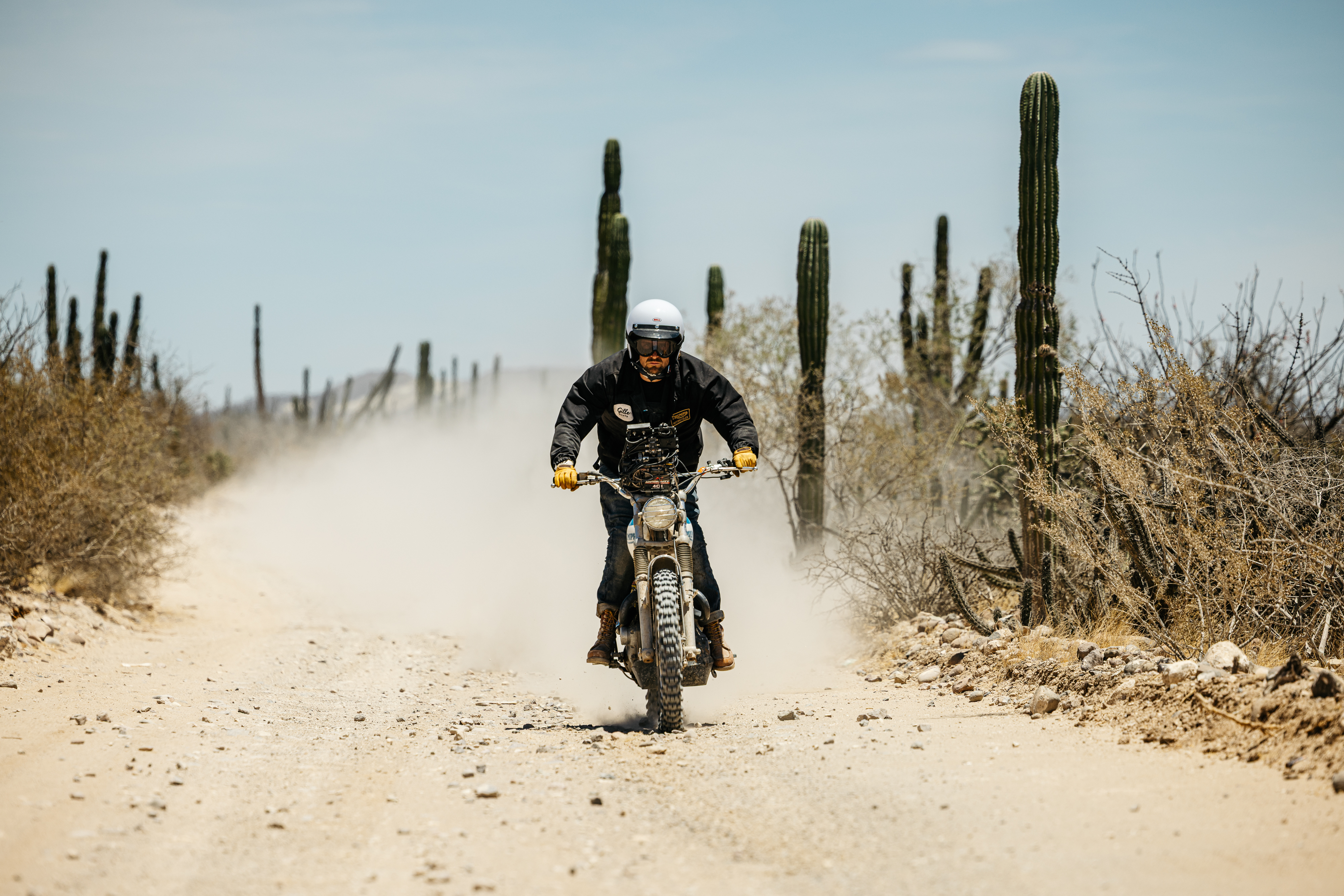 3 men in the desert wearing Triumph Heritage Clothing