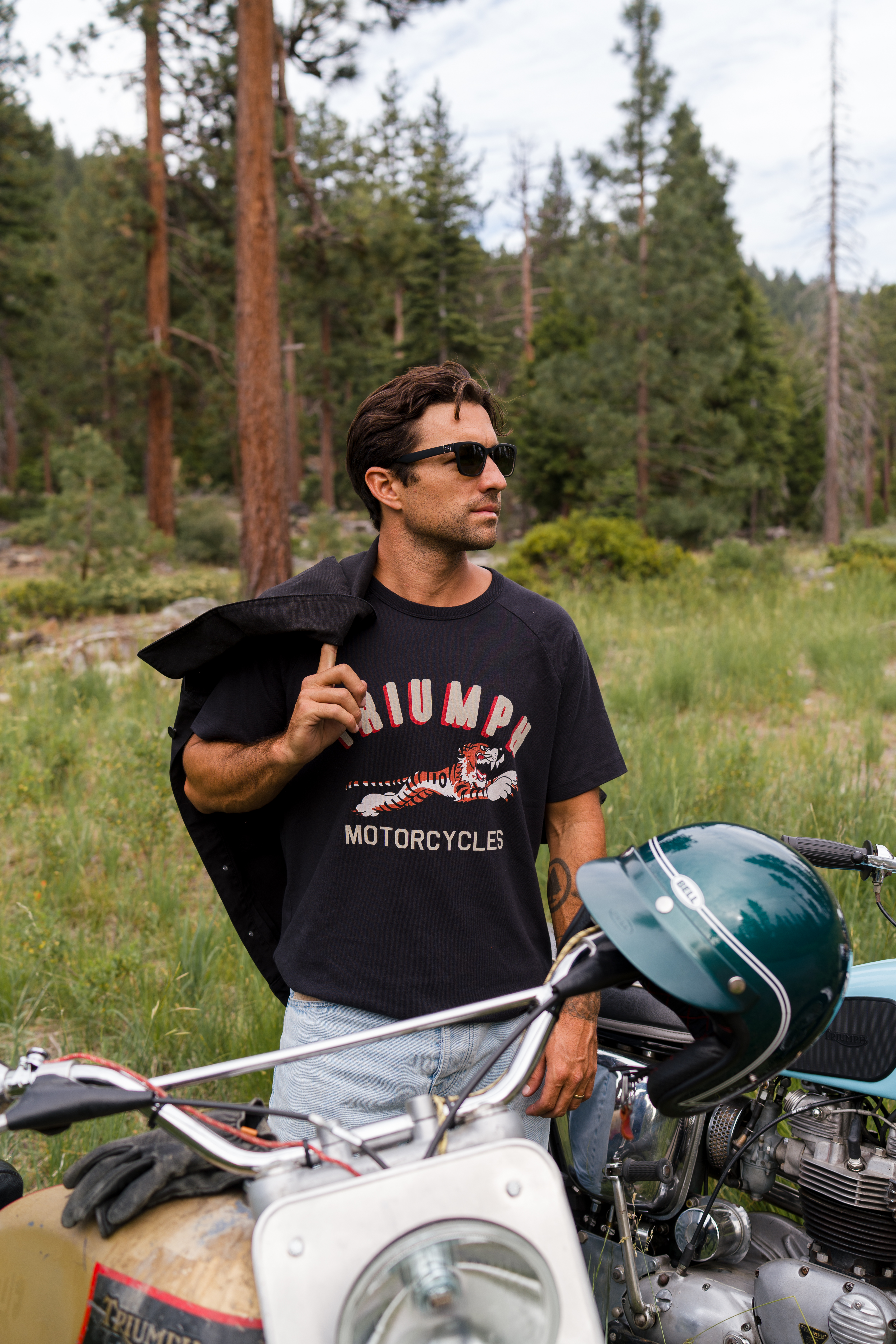 Man stood in a workshop wearing a Triumph Heritage t-shirt