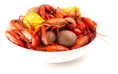 Bowl of steamed crawfish, corn, and potatoes.