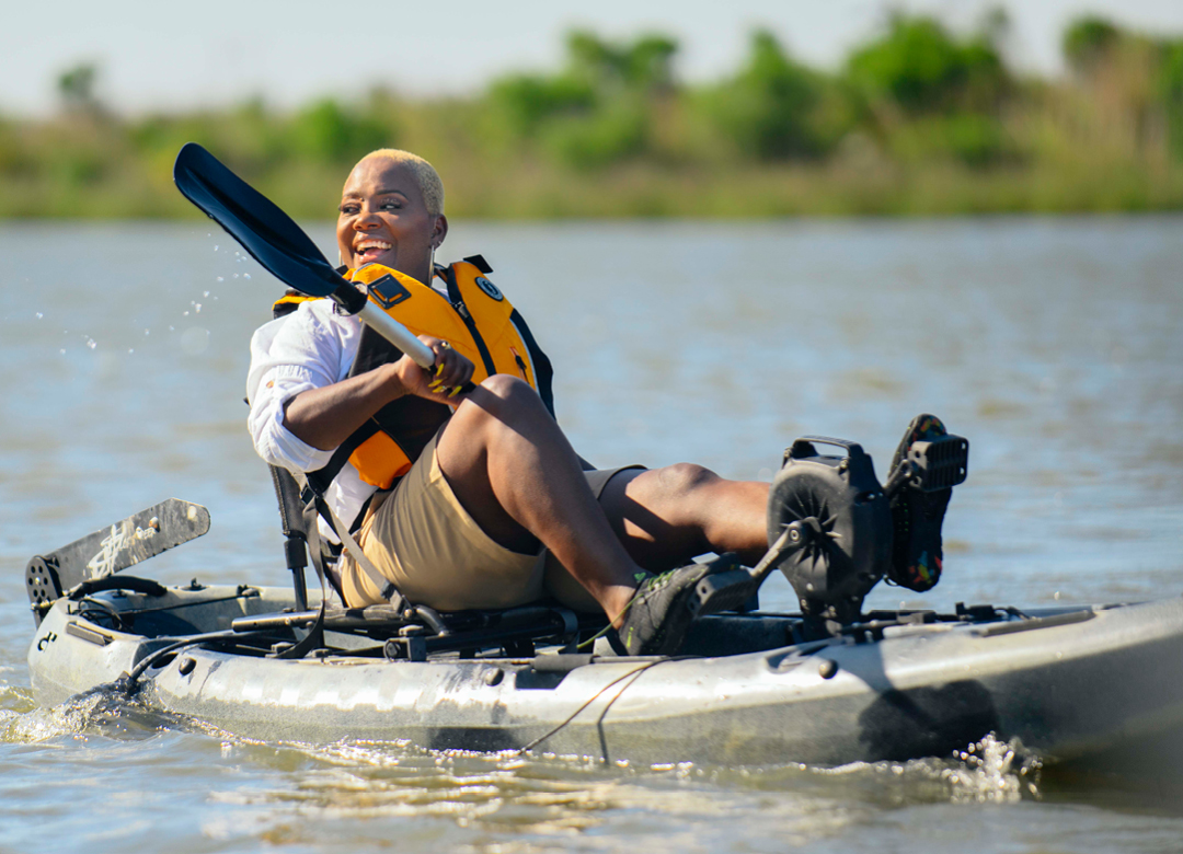 woman kayaking while wearing waterproof hearing aids